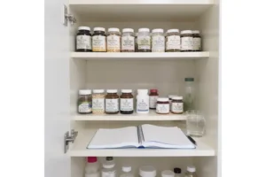 A cabinet with an organized medicine section